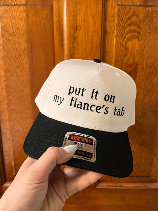 Put it on my fiancé's tab Trucker Hat